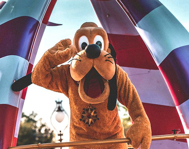 Pluto waving hello at Disneyland